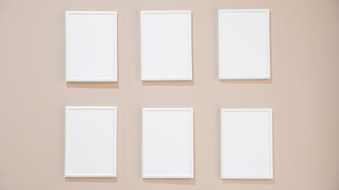 6 blank frames hanging on a wall